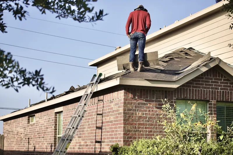 Professional roofer working on a residential roof in Huntington Station